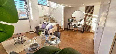 an attic room with two beds and a staircase at Apartamento Ciudad de Las Ciencias - Apartamento Ciudad de Les Arts in Valencia