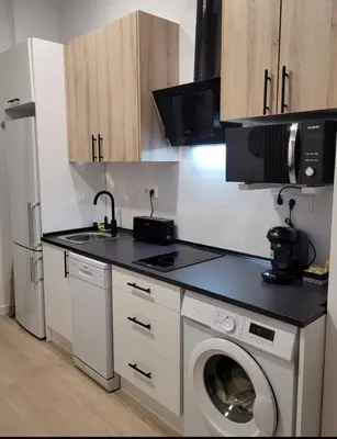 a kitchen with a washing machine and a refrigerator at Apartamento loft con encanto Suite Home Valencia in Valencia
