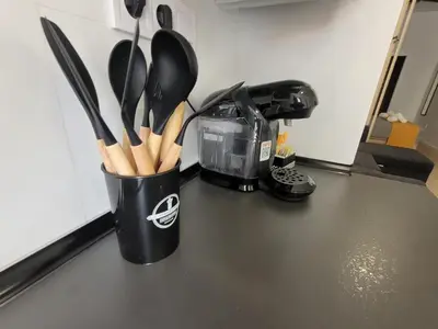a cup filled with wooden utensils on a counter at Apartamento loft con encanto Suite Home Valencia in Valencia