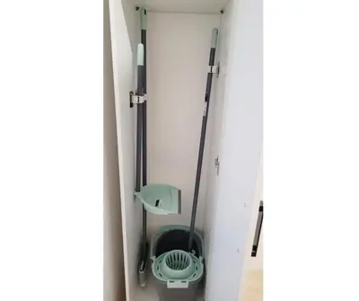 a room with two mop and a chair in it at Apartamento loft con encanto Suite Home Valencia in Valencia