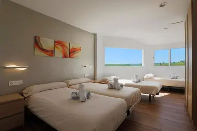 a bedroom with two beds and a bath room at Fantasy Villa Valencia - Airport & Circuit Ricardo Tormo in Chiva