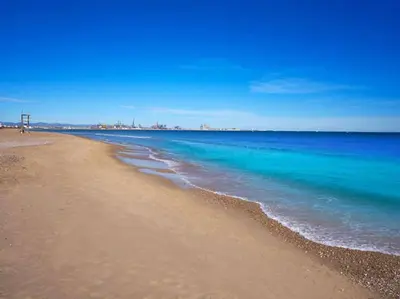 a beach with the ocean and blue water at Fantasy Villa Valencia - Airport & Circuit Ricardo Tormo in Chiva