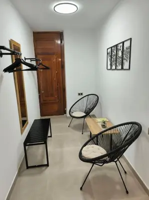 a room with two chairs and a table and a door at Casa Otilia, Aventura y Relax in Buñol