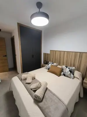a bedroom with a large bed with towels on it at Casa Otilia, Aventura y Relax in Buñol