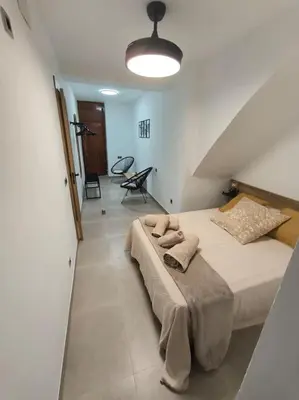 a bedroom with a large bed and a staircase at Casa Otilia, Aventura y Relax in Buñol