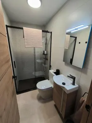 a bathroom with a shower and a toilet and a sink at Casa Otilia, Aventura y Relax in Buñol