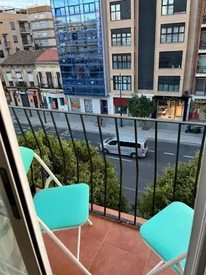 a balcony with chairs and a view of a street at Precioso apartamento al lado de la Ciudad de las Artes in Valencia