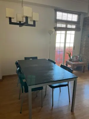 a dining room table with chairs in a room at Precioso apartamento al lado de la Ciudad de las Artes in Valencia