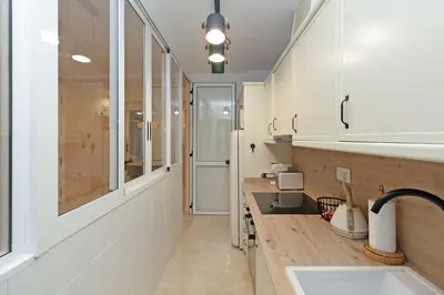 a kitchen with white cabinets and a sink and a window at GuestReady - Urban retreat in Valencia in Valencia
