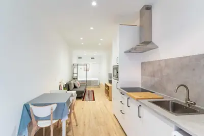 a kitchen and living room with a sink and a table at Invalencia - Sant Jordi 1 Stylish Studio in Valencia