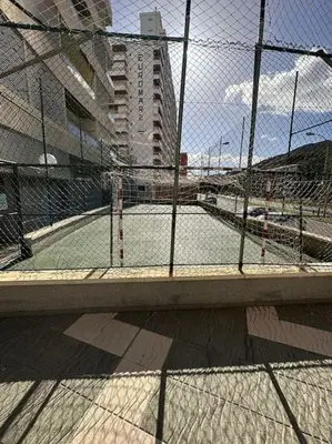 a tennis court behind a chain link fence at Apto con encanto en primera línea de playa , Cullera in Cullera