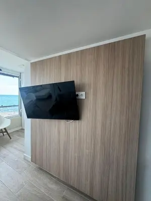a flat screen tv on a wall in a room at Apto con encanto en primera línea de playa , Cullera in Cullera