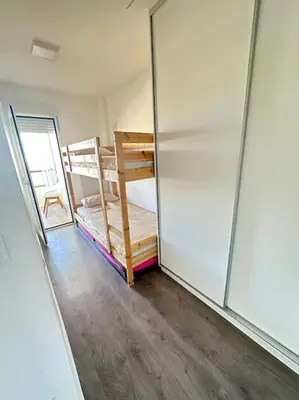a room with a bunk bed and a glass wall at Apto con encanto en primera línea de playa , Cullera in Cullera