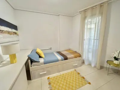 a small bedroom with a bed and a window at Valencia Beach Home 22 in Valencia