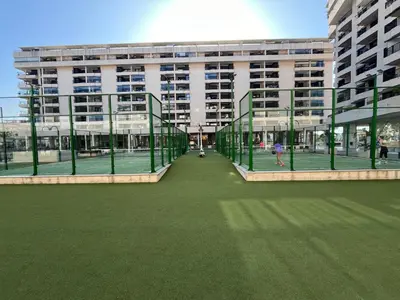 a large building with a tennis court in front of it at Valencia Beach Home 22 in Valencia