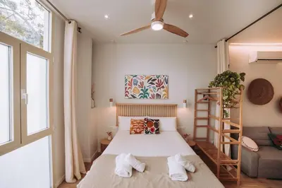 a small bedroom with a bed and a window at Apartamento junto a Ruzafa in Valencia