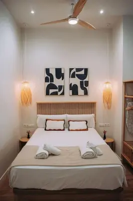 a bedroom with a large bed with two towels on it at Apartamento junto a Ruzafa in Valencia