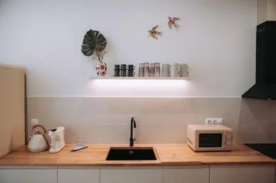 a kitchen counter with a sink and a microwave at Apartamento junto a Ruzafa in Valencia