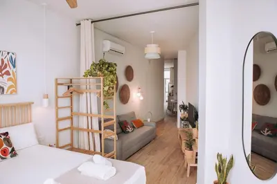a small apartment with a bed and a living room at Apartamento junto a Ruzafa in Valencia
