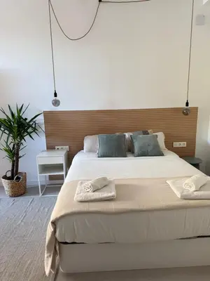 a bedroom with a large bed with two towels on it at Loft Mar Ruzafa-Parque central in Valencia