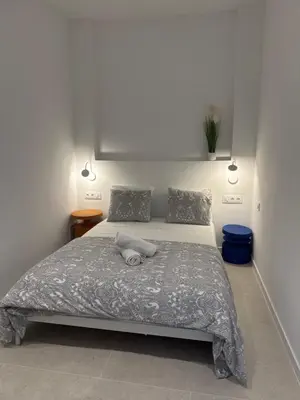 a bedroom with a large bed with a gray blanket at MAGNO Loft- CIENCIAS in Valencia