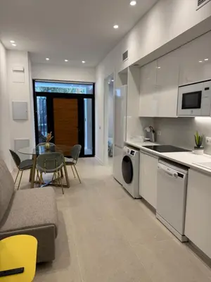 a kitchen and living room with a table and chairs at MAGNO Loft- CIENCIAS in Valencia