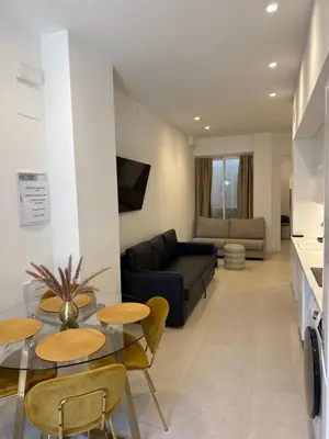 a living room with a couch and a table and chairs at MAGNO Loft- CIENCIAS in Valencia