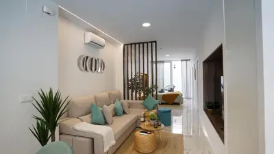 a living room with a white couch and blue pillows at Modern Loft in Patraix, Valencia - Near City Center in Valencia