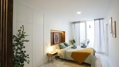a bedroom with a bed and a large window at Modern Loft in Patraix, Valencia - Near City Center in Valencia