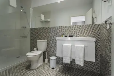 a bathroom with a toilet and a sink and a shower at Hotel San Lorenzo Boutique Plaza in Valencia