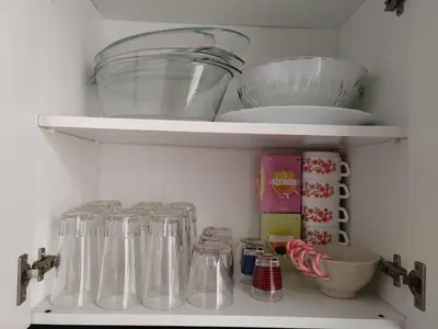 a refrigerator filled with lots of clear dishes and bowls at Vacances à la plage in Puerto de Sagunto