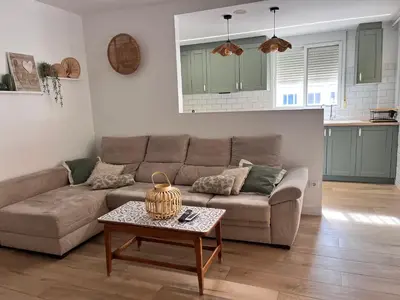 a living room with a couch and a table at 1Apartamento con piscina 2 linea de playa con acc valencia in Puzol