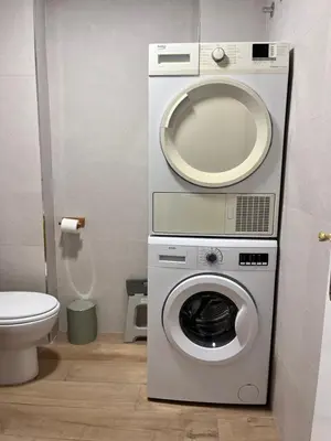 a bathroom with a washing machine and a sink at 1Apartamento con piscina 2 linea de playa con acc valencia in Puzol