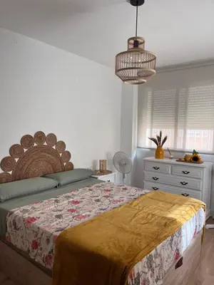 a bedroom with a large bed and a dresser at 1Apartamento con piscina 2 linea de playa con acc valencia in Puzol