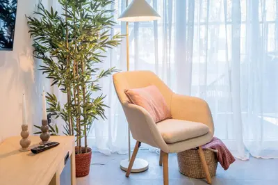 a chair sitting next to a desk with two plants at Loft HomeValencia in Valencia