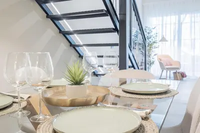 a table with plates and wine glasses on it at Loft HomeValencia in Valencia