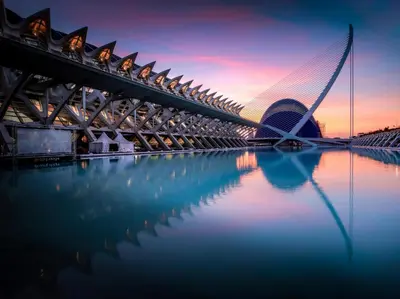 a bridge over a body of water with a building at Loft HomeValencia in Valencia