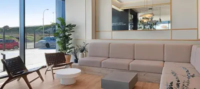 a living room with a couch and two chairs at B&B HOTEL Valencia Alcàsser in Alcácer