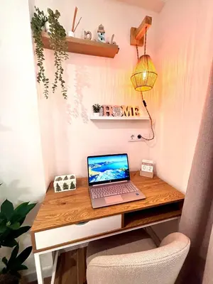 a laptop computer sitting on a desk with a lamp at Brisa Marina Stay a unos pasos del mar in Valencia