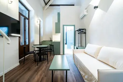 a living room with a couch and a table at VLC HOST - Reina 168 in Valencia