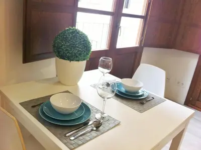 a table with two plates and a glass of wine at Superb Central Market Apt in Valencia