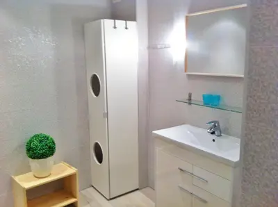 a bathroom with a sink and a white refrigerator at Superb Central Market Apt in Valencia