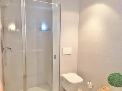 a bathroom with a toilet and a glass shower at Superb Central Market Apt in Valencia