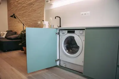 a washer and dryer in a living room at Parc Central Mint Apartment in Valencia