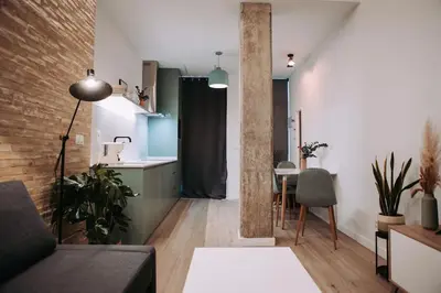 a living room with a couch and a table and a kitchen at Parc Central Mint Apartment in Valencia