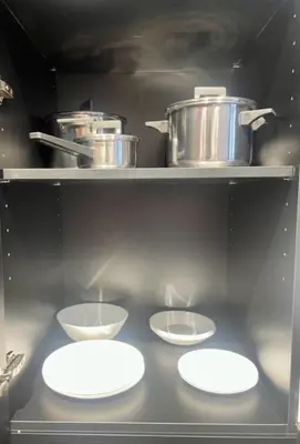 a kitchen with three bowls and pots on a shelf at Apartahotel Espai Verd Benimaclet in Valencia