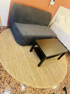 a couch and a coffee table in a bedroom at Apartahotel Espai Verd Benimaclet in Valencia