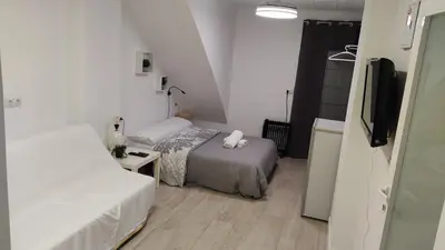 a small room with two beds and a flat screen tv at b1 Estudio independiente junto Aeropuerto in Manises