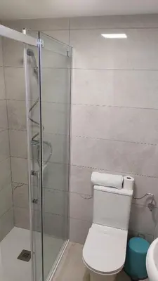 a bathroom with a toilet and a glass shower at b1 Estudio independiente junto Aeropuerto in Manises