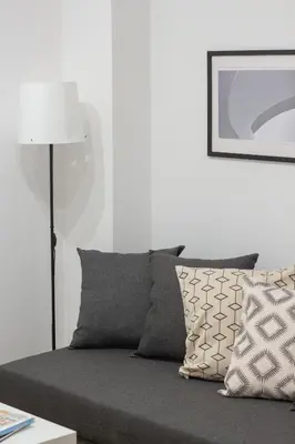 a couch with pillows and a lamp in a living room at VLC HOST- B&B Fray Pedro in Valencia